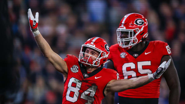Georgia Bulldogs wide receiver Ladd McConkey (84) celebrates after a touchdown with offensive lineman Amarius Mims (65) against the Mississippi Rebels in the first quarter at Sanford Stadium.